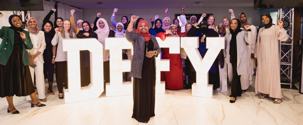 Dr. Qaali Hussein and a group of women at motivational Defiant Women's Leadership Conference