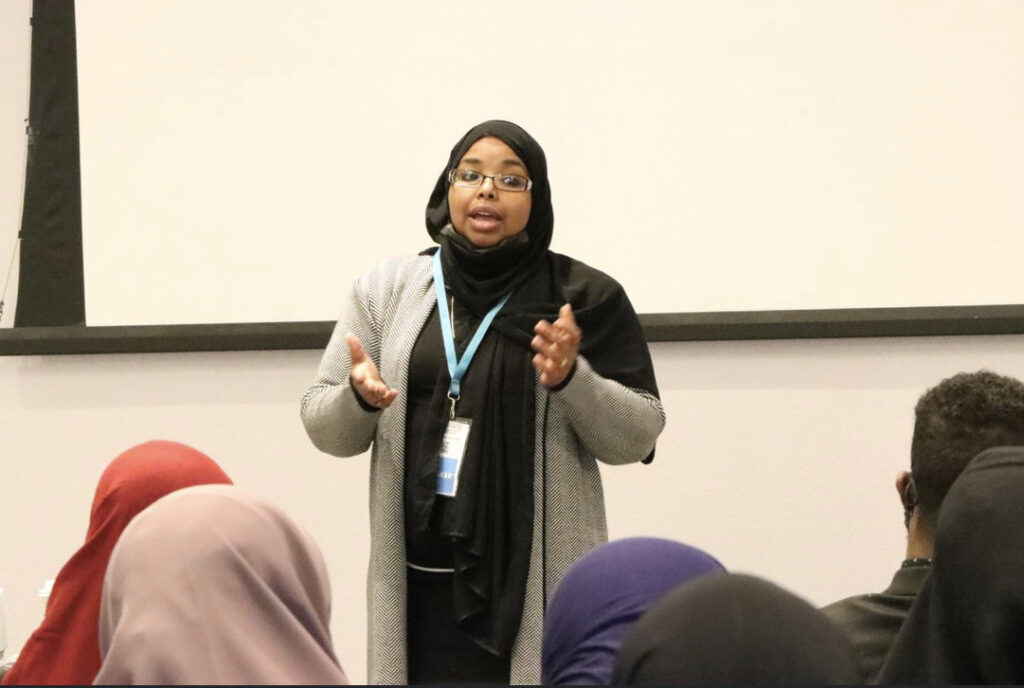 Dr. Qaali Hussein teaching how to avoid burnout and achieve balance at a career conference